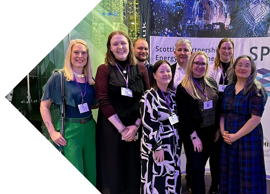 Group photo of the clean energy team in front of SPEERI banner.